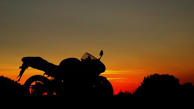 Motorcycle grass sunset silhouette trees free wallpaper for desktop - medium preview image