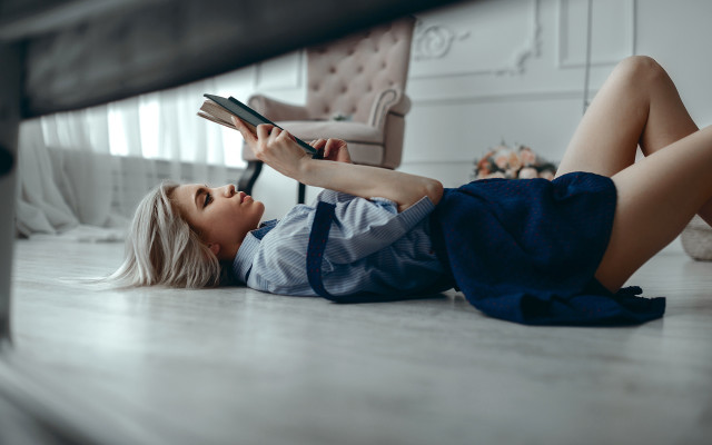 Woman reading on floor blurry free wallpaper for desktop - medium preview image