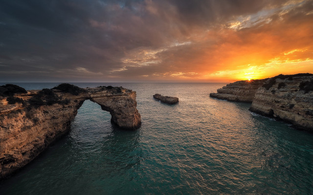 Sunset water rock arch beach free wallpaper for desktop - medium preview image