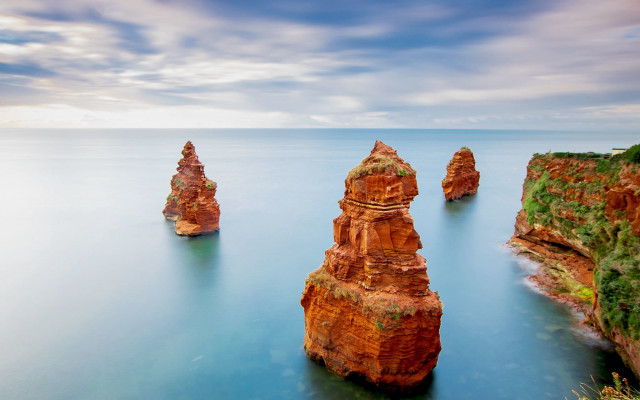 Rocky outcrop beach cloudy sky free wallpaper for desktop - medium preview image