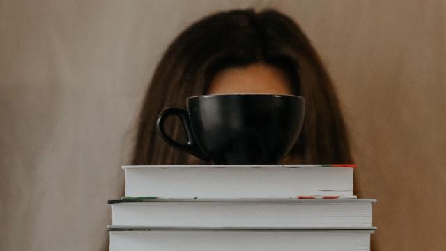 Woman hiding books coffee art free wallpaper for desktop - medium preview image