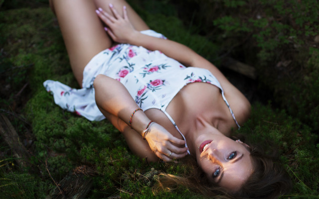 Woman lying on grass dappled free wallpaper for desktop - medium preview image