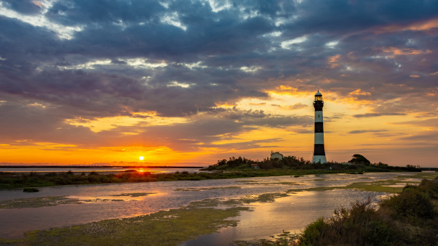 Lighthouse sunset clouds island beach free wallpaper for desktop - medium preview image