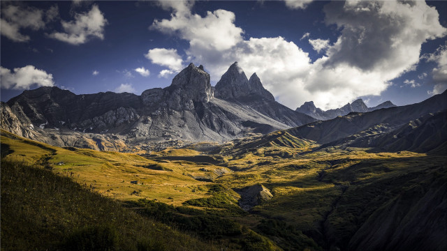 Mountain range clouds grassy valley free wallpaper for desktop - medium preview image