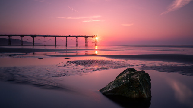 Sunset pier rock beach matte free wallpaper for desktop - medium preview image