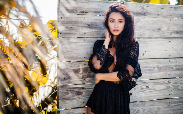 Woman black dress leaning against free wallpaper for desktop - medium preview image