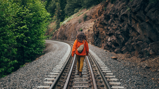 Woman traintracks woods backpack tiltshift free wallpaper for desktop - medium preview image