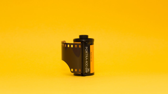 Camera battery yellow background black free wallpaper for desktop - medium preview image