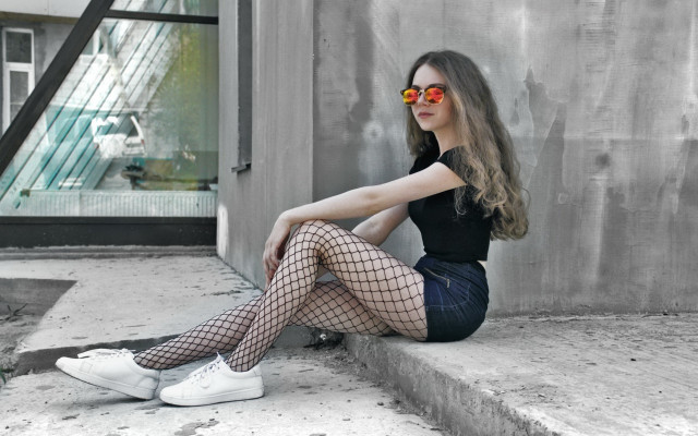 Woman fishnets sunglasses ledge building free wallpaper for desktop - medium preview image