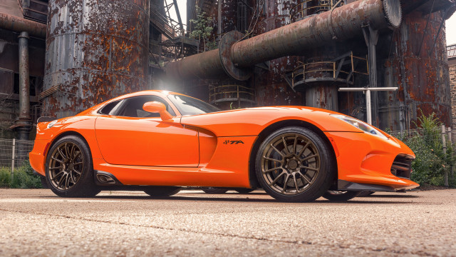 Bright orange sports car factory free wallpaper for desktop - medium preview image
