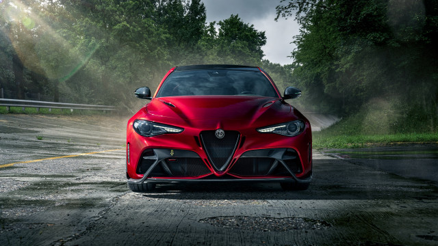 Red sports car driving forest free wallpaper for desktop - medium preview image