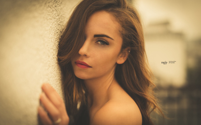 Woman leaning wall long hair free wallpaper for desktop - medium preview image