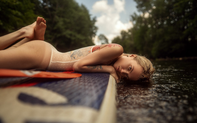 Tattooed woman surfboard water blurry free wallpaper for desktop - medium preview image