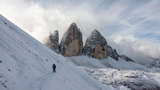 Hiking man snowy mountain clouds free wallpaper for desktop - medium preview image