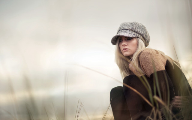Woman sitting field hat sweater free wallpaper for desktop - medium preview image