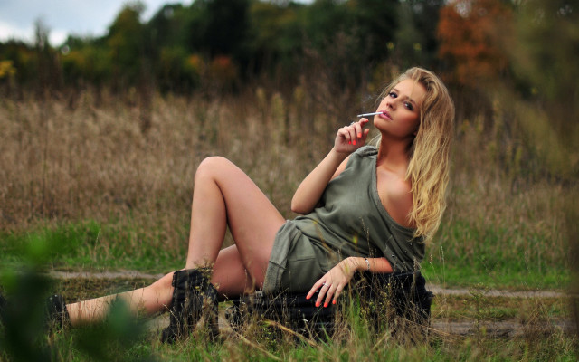 Woman smiling sitting field nature free wallpaper for desktop - medium preview image