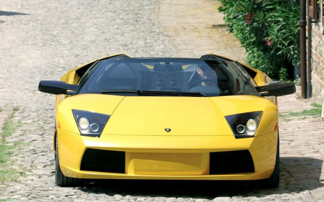 Yellow sports car cobblestone road free wallpaper for desktop - medium preview image