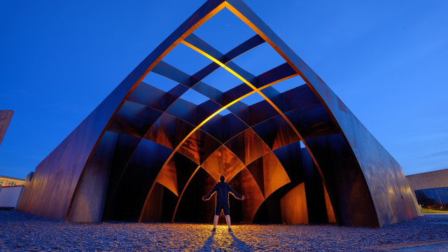 Person metalstructure blueSky trianglebuilding scenery free wallpaper for desktop - medium preview image