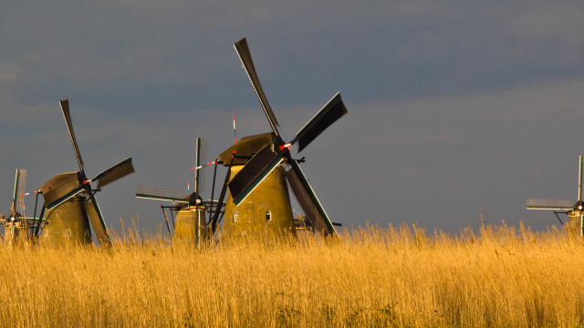 Windmills tallgrass cloudy sky explosion free wallpaper for desktop - medium preview image