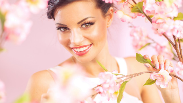 Woman smiling pink background flower free wallpaper for desktop - medium preview image