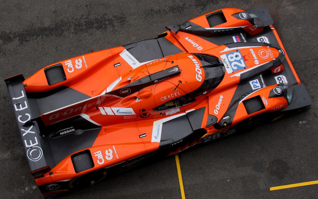 Orange race car parking lot free wallpaper for desktop - medium preview image