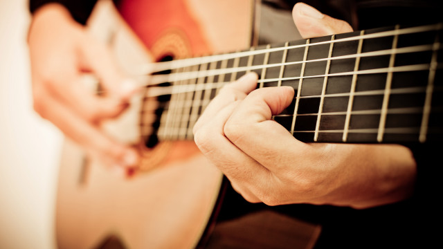 Guitar hands strings foreground background free wallpaper for desktop - medium preview image
