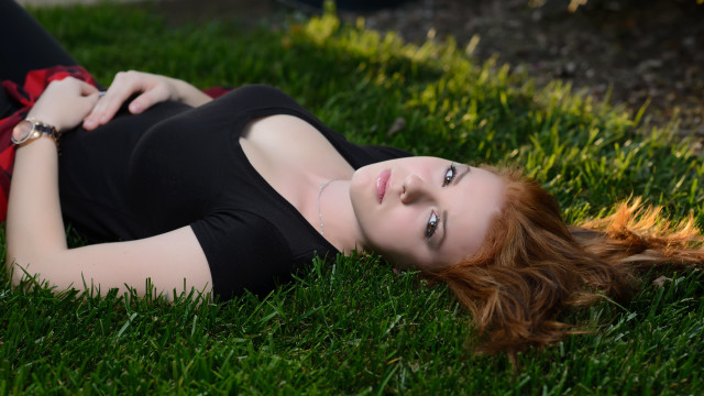 Woman laying on grass blurry #2 free wallpaper for desktop - medium preview image