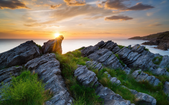 Sunset cliff grass rocks water free wallpaper for desktop - medium preview image
