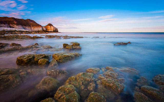 Rocky beach cliff blue sky free wallpaper for desktop - medium preview image