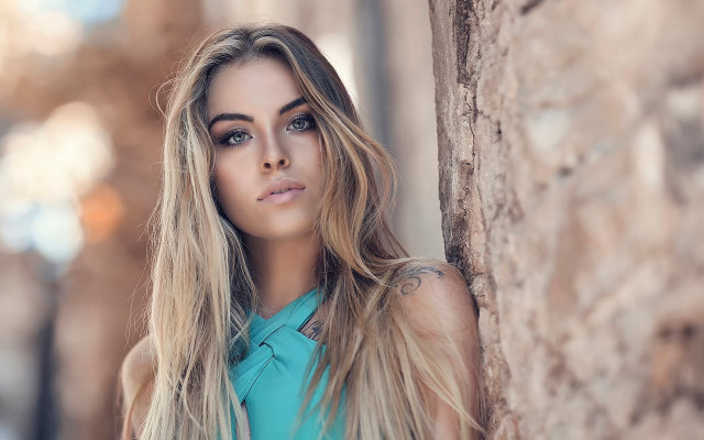 Woman leaning wall blonde serious free wallpaper for desktop - medium preview image