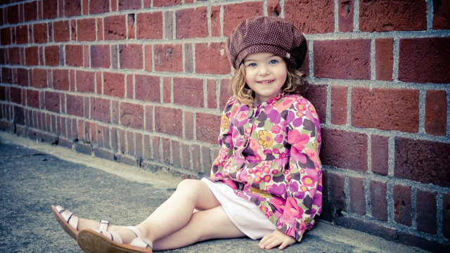 Little girl brick wall smiling free wallpaper for desktop - medium preview image
