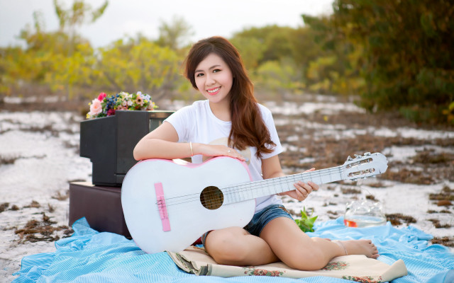 Woman sitting guitar smiling beach free wallpaper for desktop - medium preview image