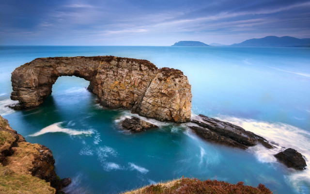 Large rock formation ocean sky free wallpaper for desktop - medium preview image