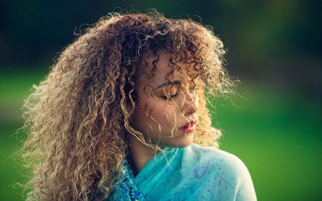 Curly haired woman blue shirt free wallpaper for desktop - medium preview image