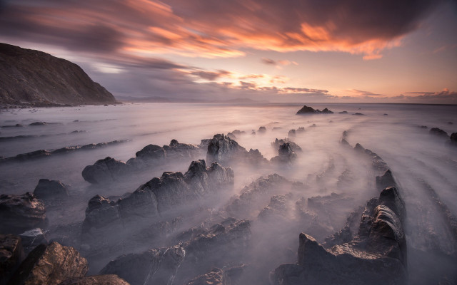 Sunset rocky beach mist orange free wallpaper for desktop - medium preview image