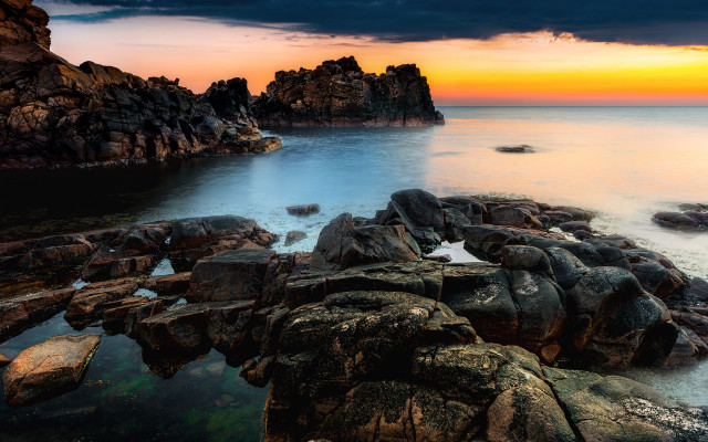 Rocky shore sunset water formation free wallpaper for desktop - medium preview image