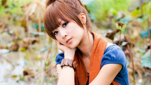 Woman blue shirt brown vest free wallpaper for desktop - medium preview image