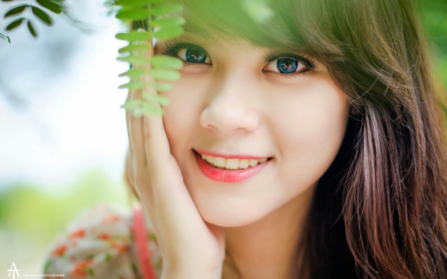 Woman blue eyes green leaf #2 free wallpaper for desktop - medium preview image