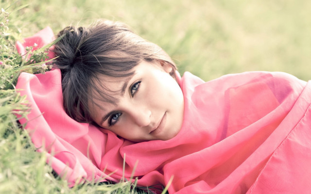 Girl smiling laying in grass free wallpaper for desktop - medium preview image