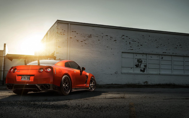 Red sports car backlit building free wallpaper for desktop - medium preview image