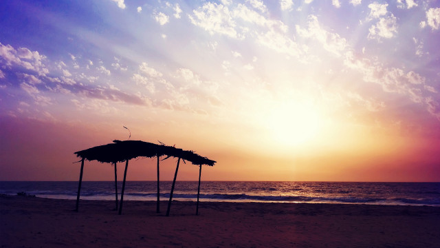 Beach sunset umbrellas clouds mountain free wallpaper for desktop - medium preview image