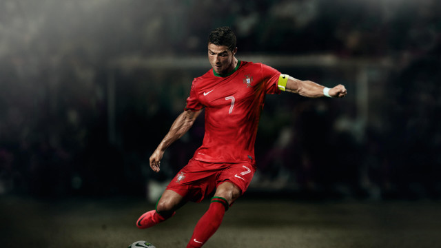 Man red uniform kicking soccer #2 free wallpaper for desktop - medium preview image
