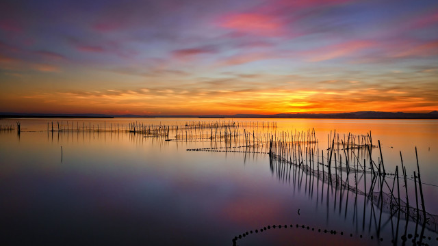 Sunset lake poles boats mystical free wallpaper for desktop - medium preview image