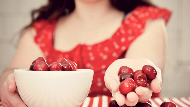 Woman cherries table bowl blurry free wallpaper for desktop - medium preview image