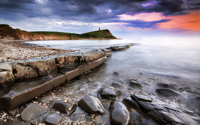 Rocky beach lighthouse cloudy sunset free wallpaper for desktop - medium preview image