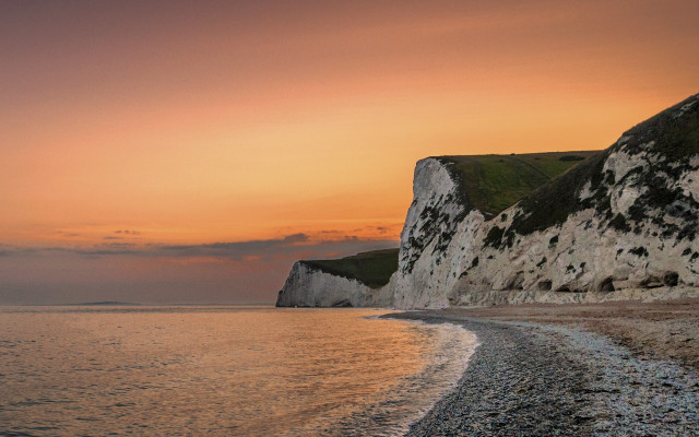Beach cliff water sunset boat free wallpaper for desktop - medium preview image