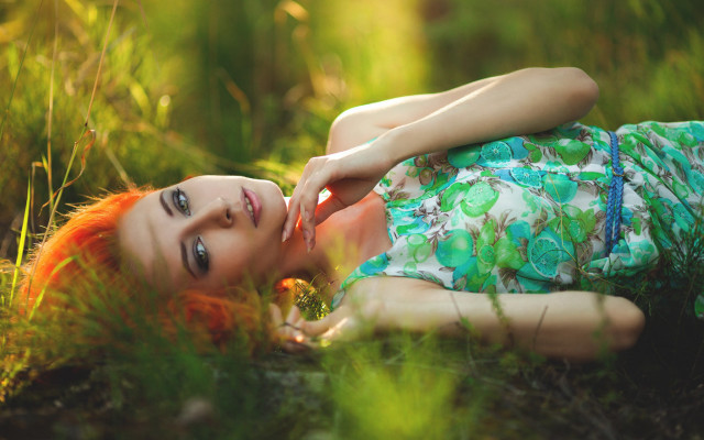 Woman lying grass outdoors blurry free wallpaper for desktop - medium preview image