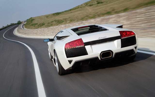 White sports car driving hillside free wallpaper for desktop - medium preview image