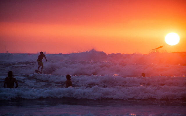 Surfing group wave ocean sunset #2 free wallpaper for desktop - medium preview image