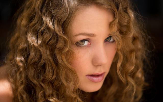 Woman curly hair serious portrait free wallpaper for desktop - medium preview image